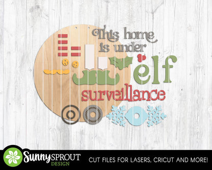 This Home Under Elf Surveillance Sign, Digital Download, SVG Laser Cut File, Cricut, Round Door Hanger Design, Funny Christmas Decor